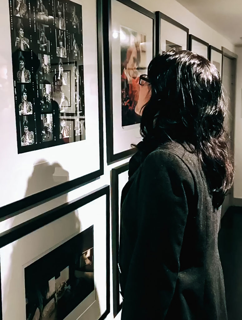 a woman looks at photographs on exhibit at the Morrison Hotel Gallery in Los Angeles