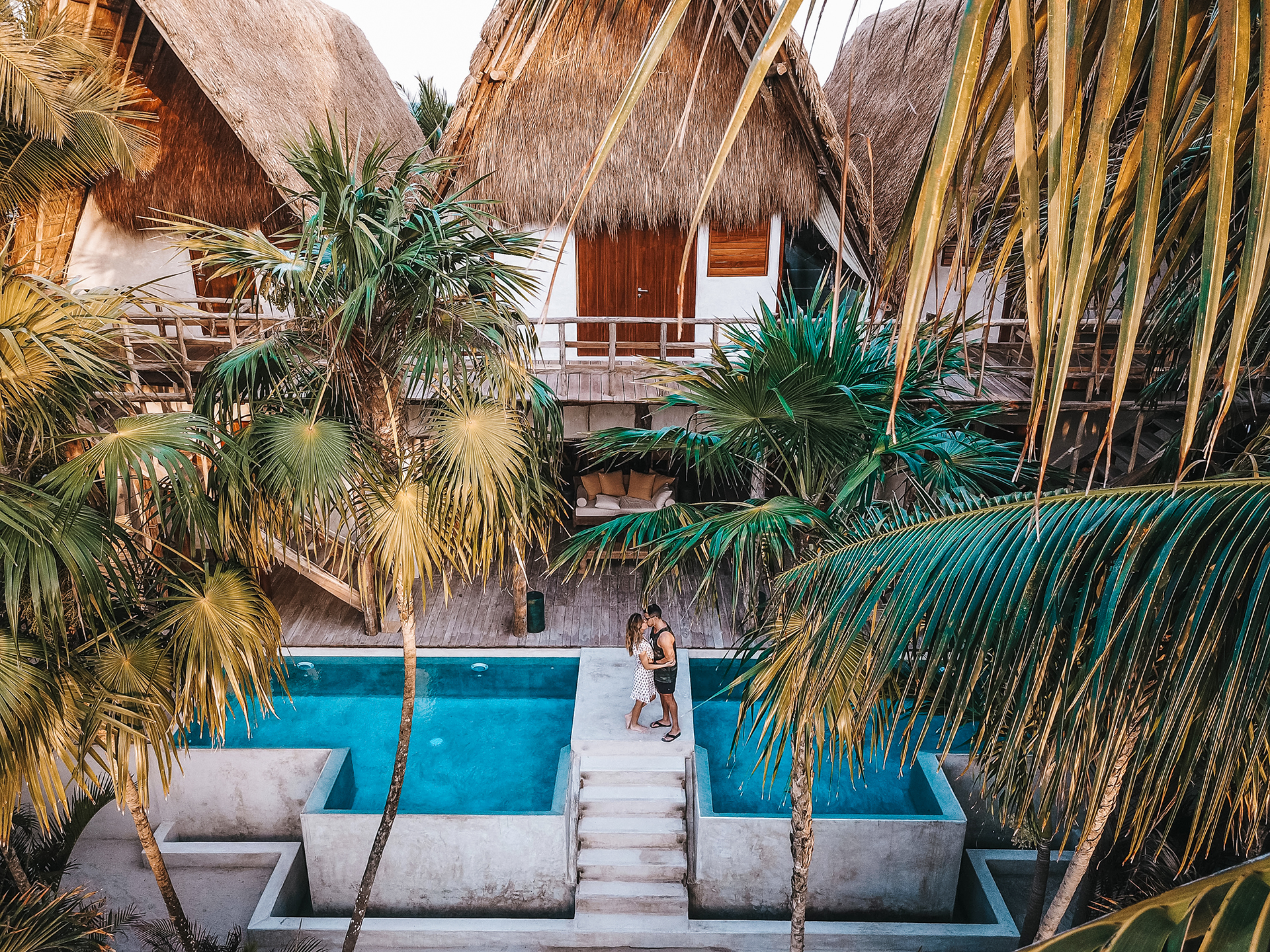 a couple enjoys a tropical vacation. With destinations becoming more open to travelers again, you might be dreaming of romantic getaways and experiences to share with your lover.