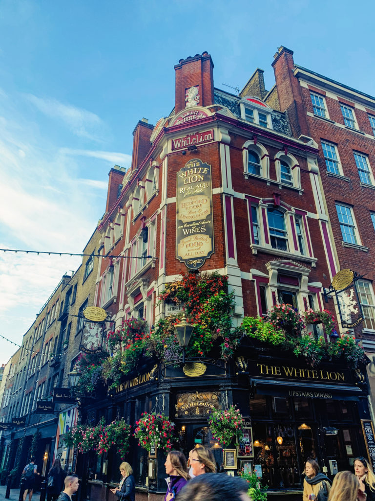 The White Lion pub covered in flowers