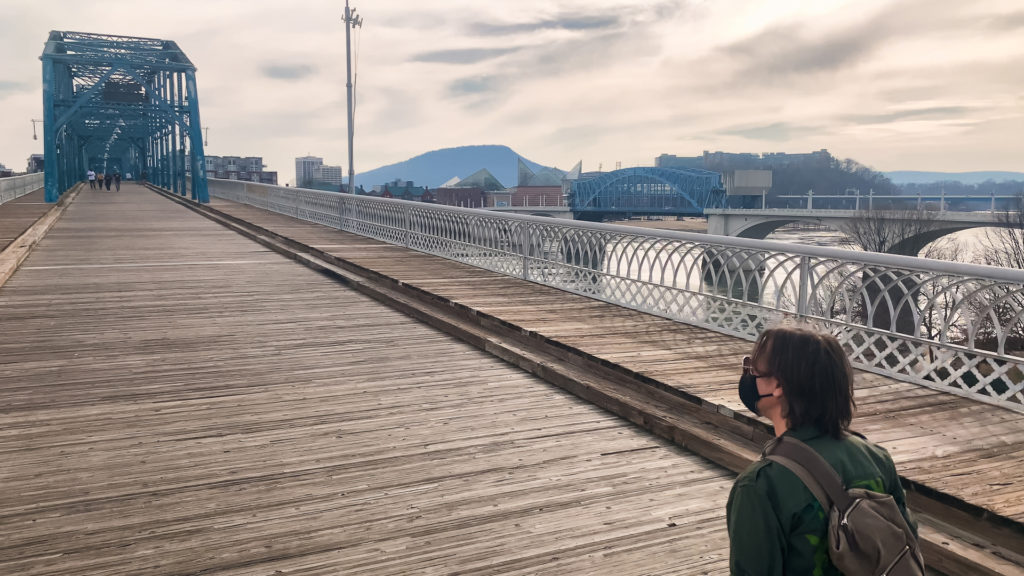 a man crosses the Walnut Street Bridge in Chattanooga