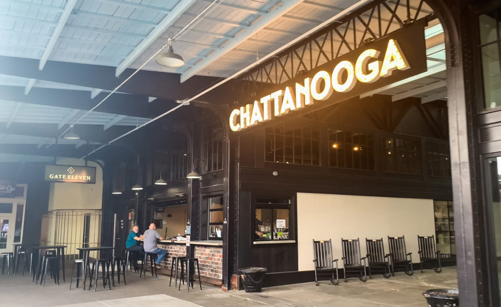 a glowing sign reads "Chattanooga" with a bar just beyond it
