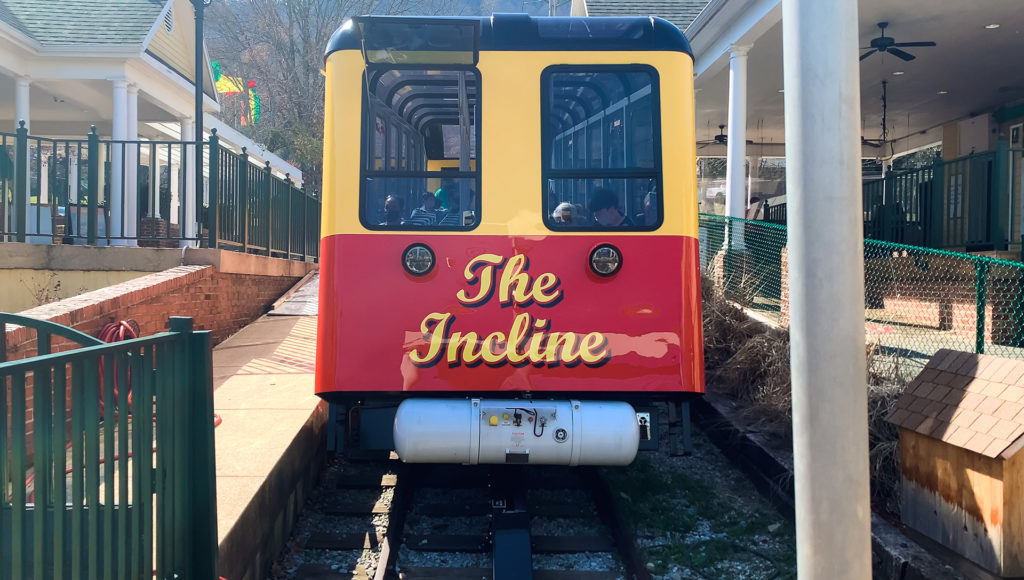 the front of a funicular train car reads "The Incline"