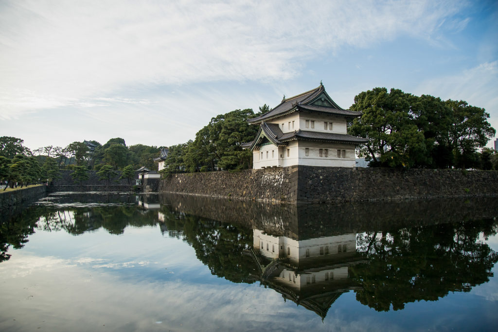 a gate tower near one of the entrances to the Imperial Palace in Tokyo, from across a body of water