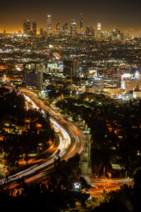 night time-lapse view of the Los Angeles skyline and blurred traffic lights