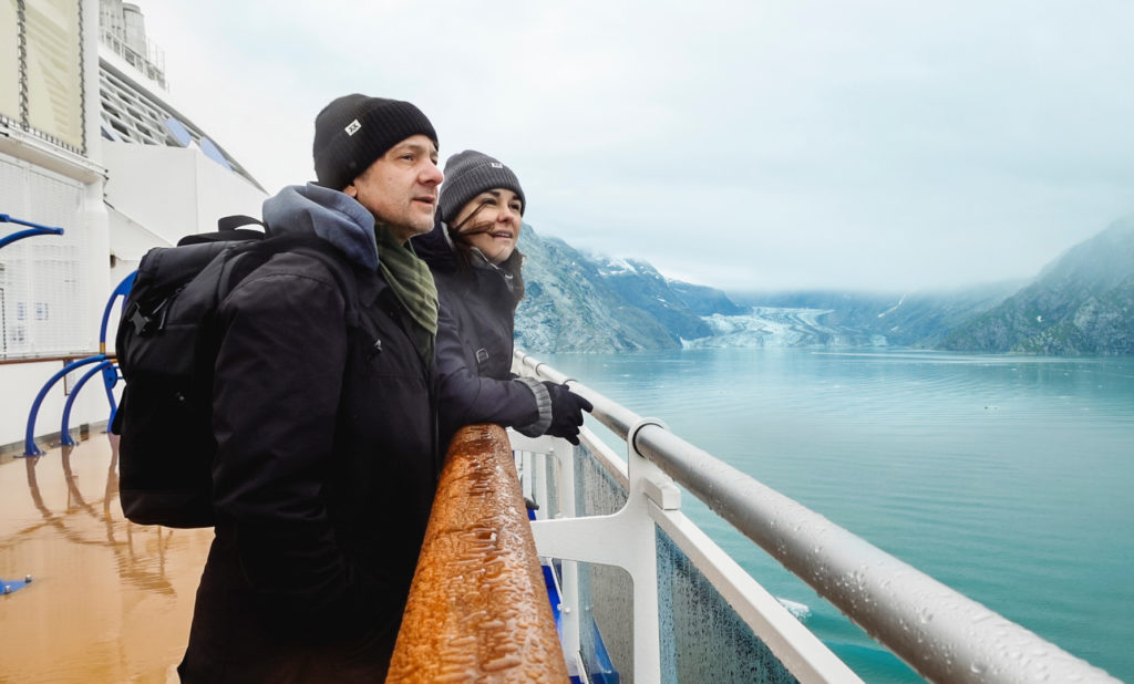 Stephen and Andie look out from the deck of a cruise ship at glaciers in Alaska