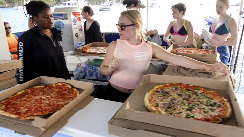 pizza delivery by Pizza Pi on the water, by dinghy, in the U.S. Virgin Islands.