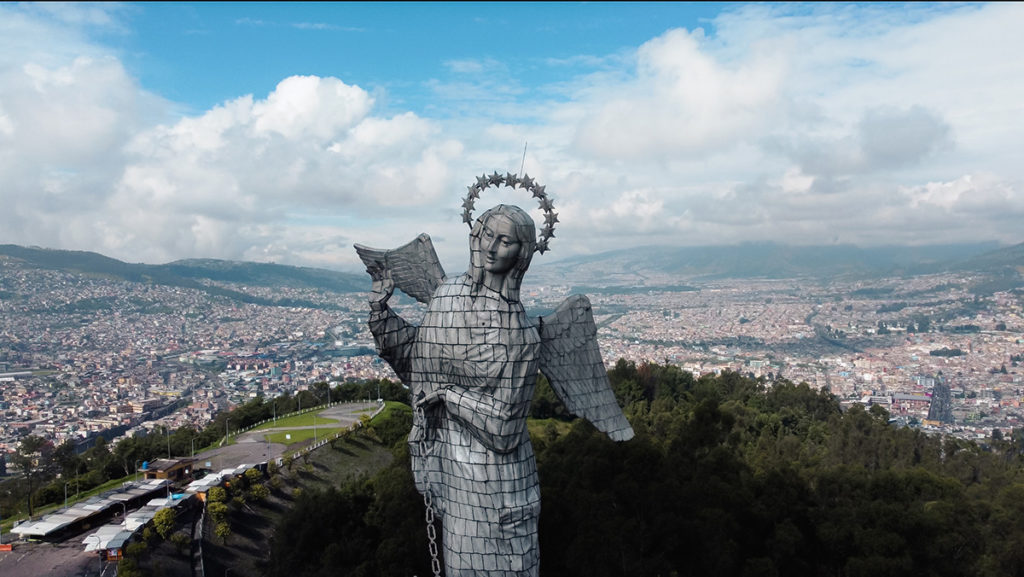 an aerial view of the Virgin of El Paneceillo overlooking the city of Quito, Ecuador