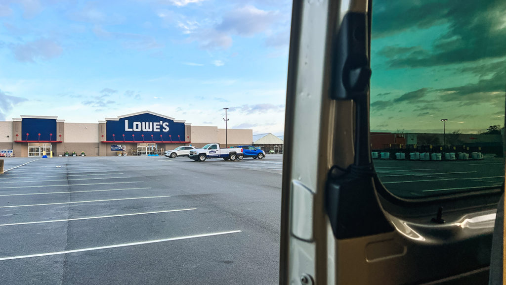 Sprinter campervan parked in Lowe's parking lot.