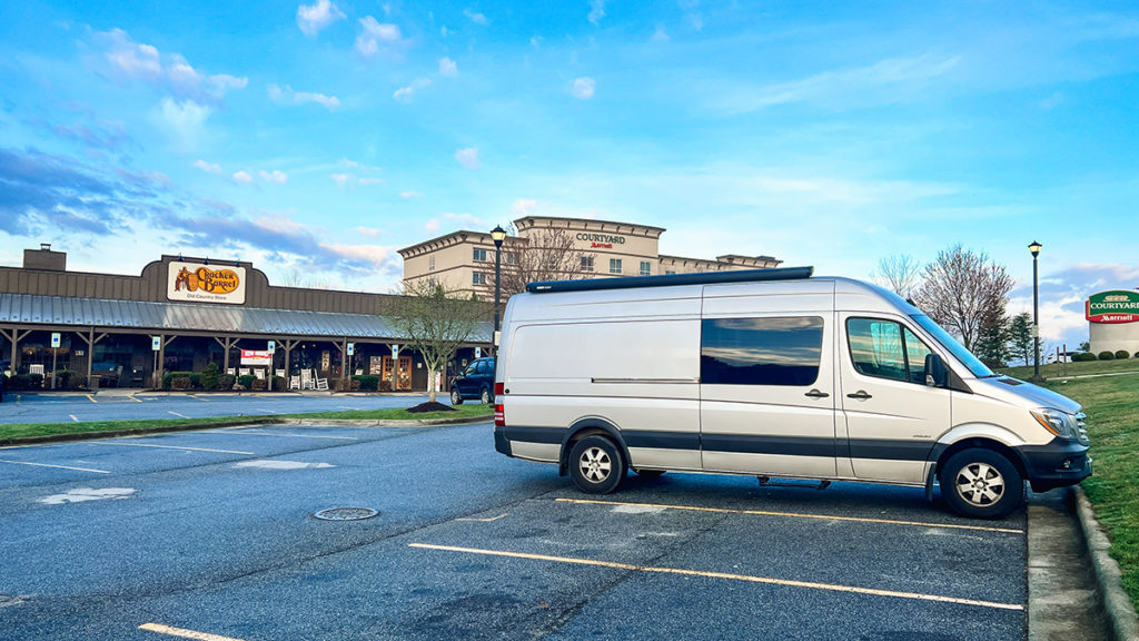 Sprinter campervan parked in front of Cracker Barrel. free overnight parking is available in designated spaces in the back or side of the restaurant.