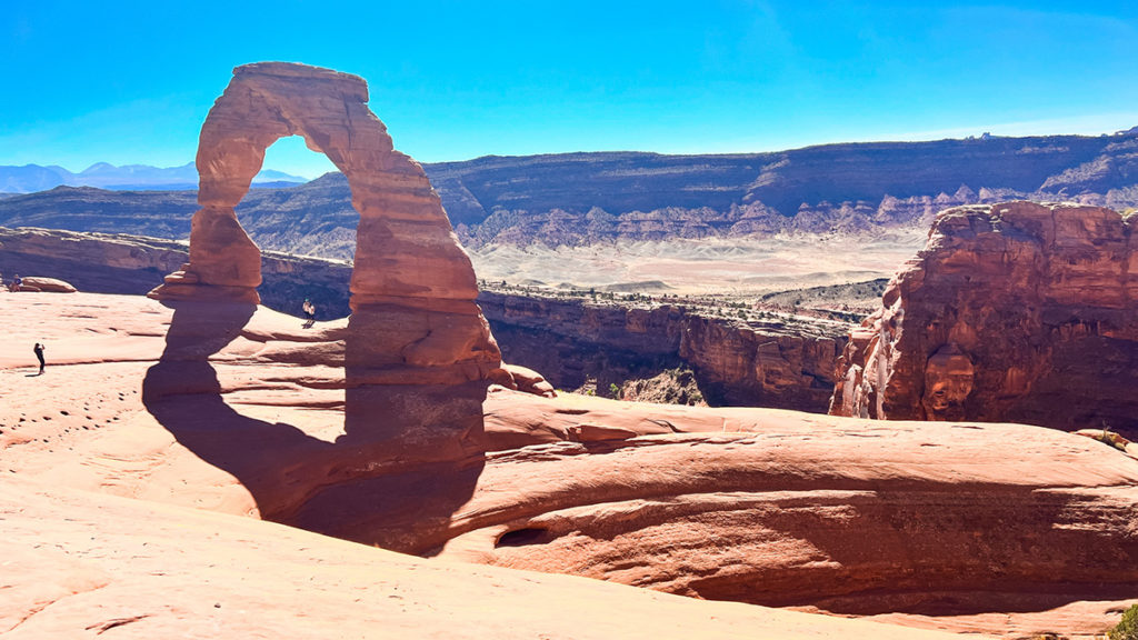 a photo of the iconic Delicate Arch at Arches National Park in Utah. on a sunny October day.