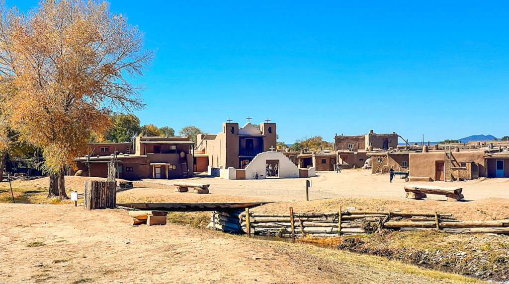 landscape photo of Taos Pueblo, New Mexico, the church is in the center